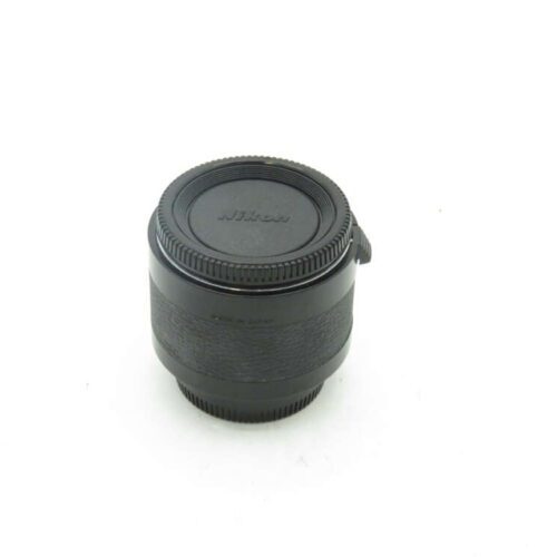 A Nikon camera lens with a front and rear cap.