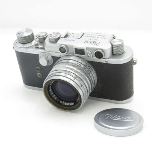 Vintage Nicca camera with a Nikkor 5cm f/1.4 lens, shown with a lens cap.