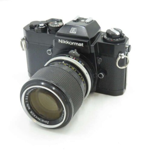 A black Nikkormat EL film camera with a 200mm Nikkor lens.