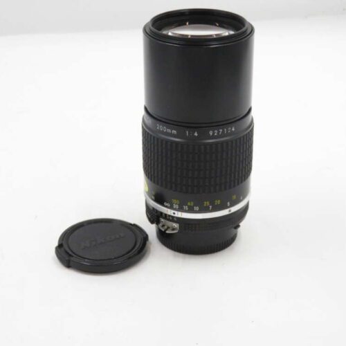 Nikon 200mm f/4 lens with detached lens cap on a white background.
