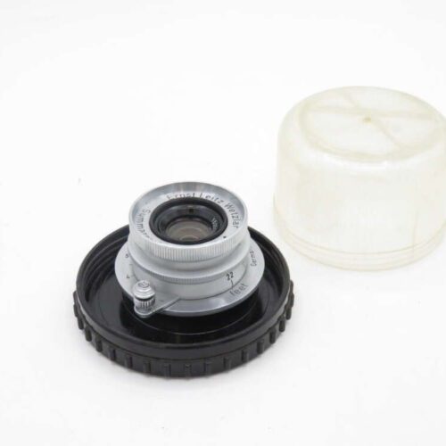 Camera lens with protective cap and cover.
