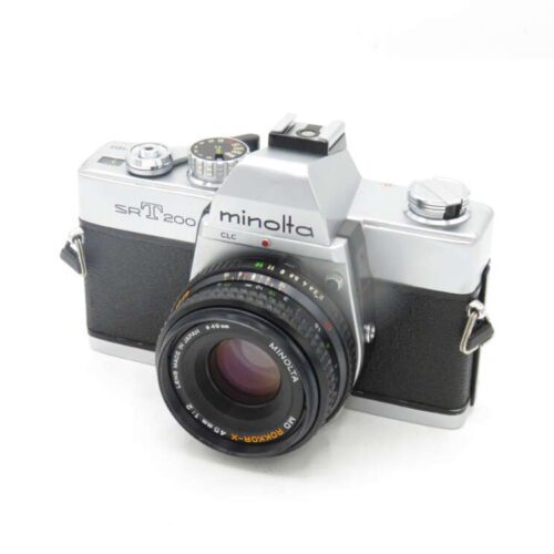Vintage Minolta SR-T 200 SLR camera with a black lens attached, on a white background.