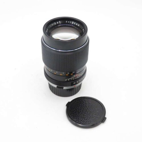 Camera lens with a detached lens cap on a white background.