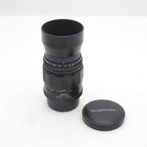 Voigtländer camera lens with its cap placed beside.