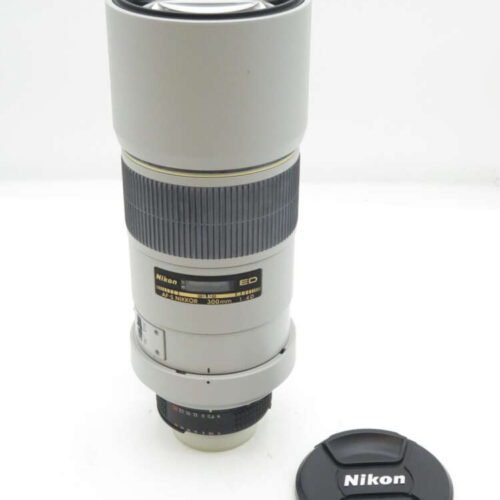 Nikon AF-I Nikkor 300mm f/4D lens in grey with a detached black lens cap.