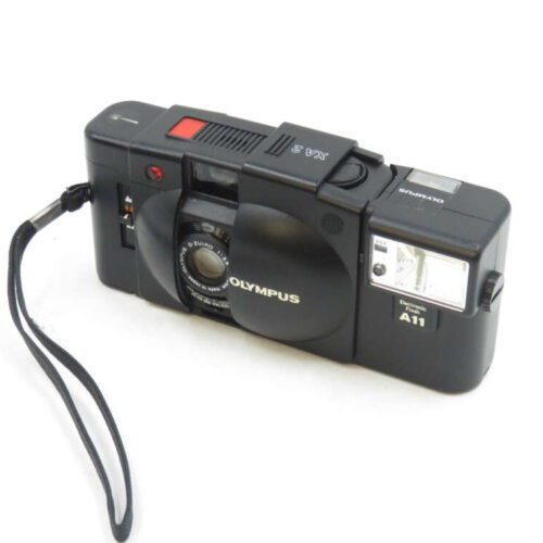 Black Olympus XA3 camera with A11 flash attachment and wrist strap.