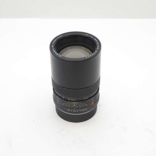 A black camera lens with markings around the barrel including aperture and focus distance indicators.