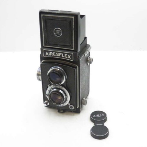 Airesflex twin-lens reflex camera with lens caps on white background.