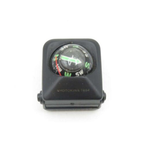 Small black compass with the text "Photokina 1984".