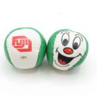 Two green and white juggling balls, one featuring a happy clown face and the other with a "FUJI" logo.