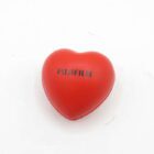 Red heart-shaped object with "FUJIFILM" printed on it.