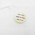 Round plastic tag with a string branding it as "AGFA Film".