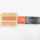 Sony Action Cam packaging with two adhesive labels on the left and a black and orange box on the right.