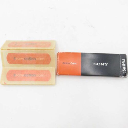 Sony Action Cam packaging with two adhesive labels on the left and a black and orange box on the right.