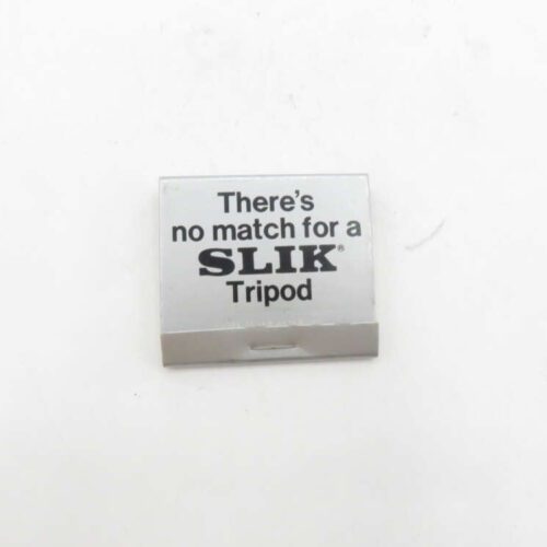 Silver matchbox with the text "There's no match for a SLIK Tripod" against a white background.