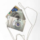 Keychain with metal beads and attached items resembling vintage digital cameras.