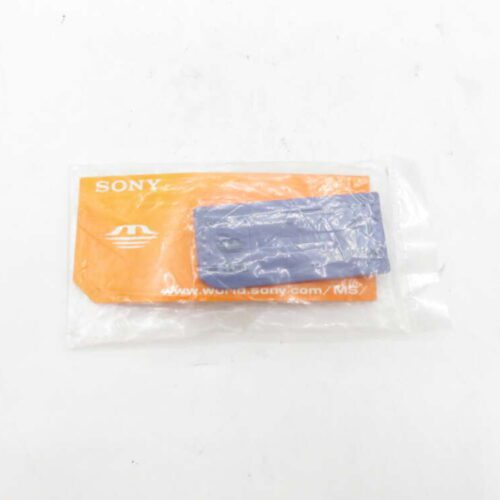 Sony memory stick in plastic packaging on an orange background.