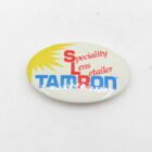 Oval badge with the text "Speciality Lens Retailer TAMRON" and a yellow sunburst design.