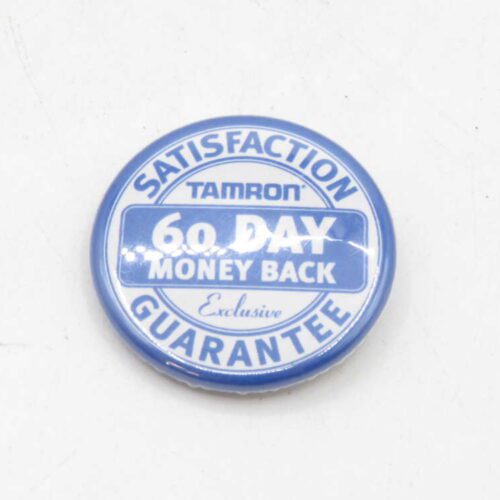 Blue and white "Satisfaction Guarantee" button badge with "Tamron", "60 Day Money Back", and "Exclusive" text.