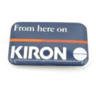 Rectangular badge with rounded corners, featuring the text "From here on KIRON" on a dark blue background with an orange stripe.