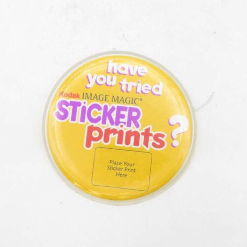 Yellow Kodak IMAGE MAGIC promotional badge reading "have you tried STICKER prints?"