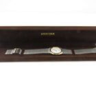 A Pentax branded wristwatch in a brown velvet-lined case.