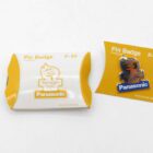 Pin badge from the Sydney 2000 Olympics, featuring a yellow and white packaging with the Panasonic logo.
