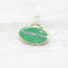 Green enamel pin with gold border and the text "fujifilm.com" in white, encased in plastic.