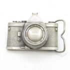 Silver-tone miniature camera figurine with textured body and "Lens Made in Japan" inscribed on the lens.