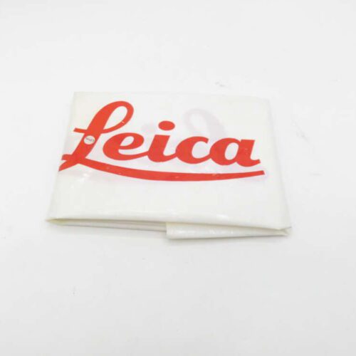 Folded white cloth with the "Leica" logo printed in red.