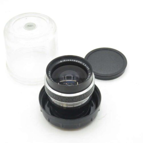 Camera lens with metal housing, placed in a plastic case with lid off and set aside.