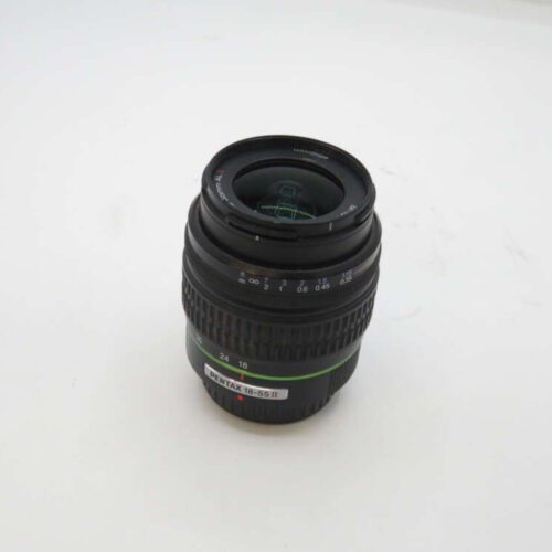 Black Pentax 18-55mm camera lens on white background.