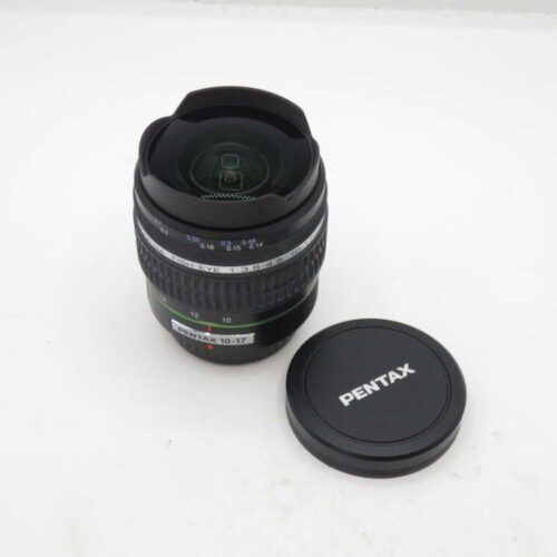 Pentax fisheye lens with lens cap on a white surface.