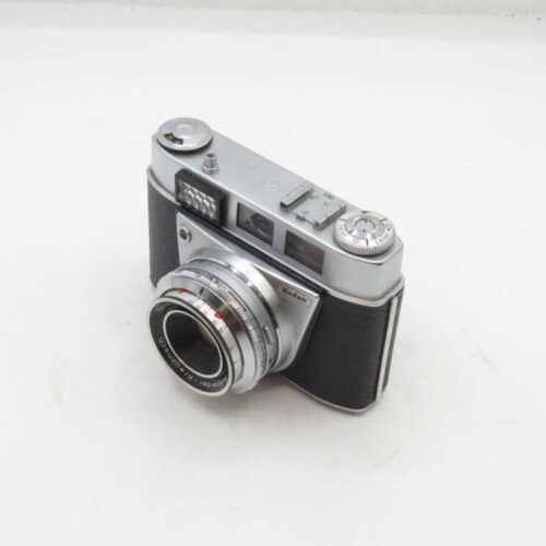 Vintage Kodak 35mm film camera with a silver metal body and black leather accents.