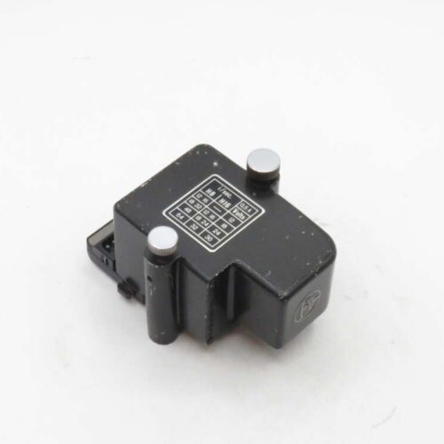 A black electronic component with a label displaying numbers and letters, featuring two metallic pins.
