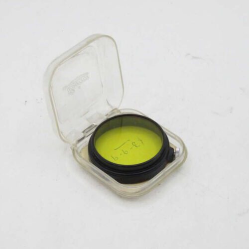 Yellow camera filter in a transparent plastic case.