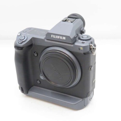 Fujifilm camera body with a lens mount cap, featuring grip and control dials.