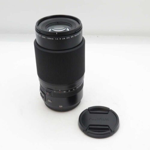 Camera lens with an attached lens hood next to a separate lens cap on a white background.