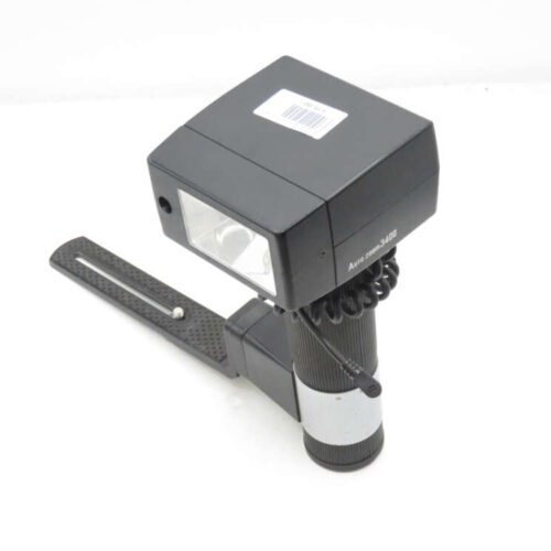 Black Auto Zoom 3400 camera flash unit with a handle and connecting coiled cord.