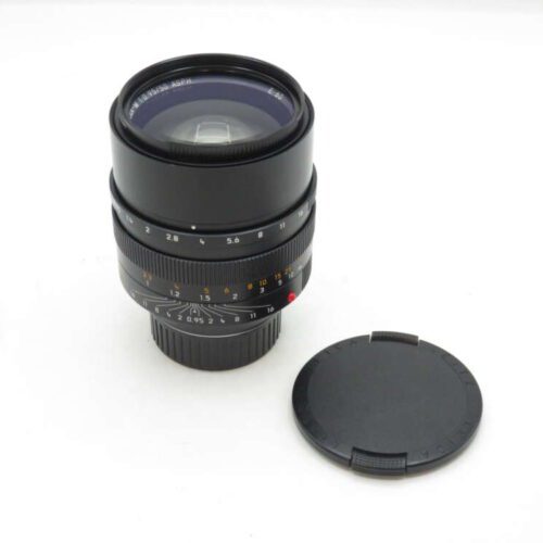 a black camera lens with a cap