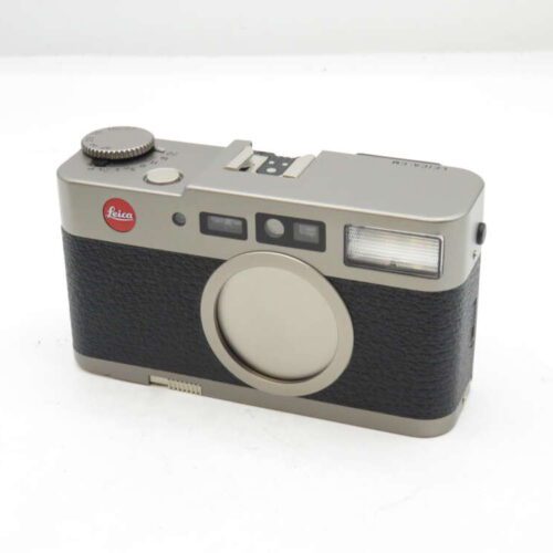 Vintage Leica film camera with a silver top and bottom, black body, and red Leica logo.