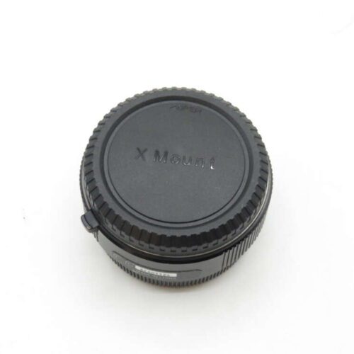 Black X Mount camera lens adapter on white background.