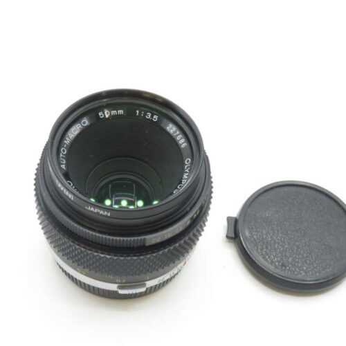 Olympus Auto-Macro 50mm f/3.5 lens with detached lens cap.