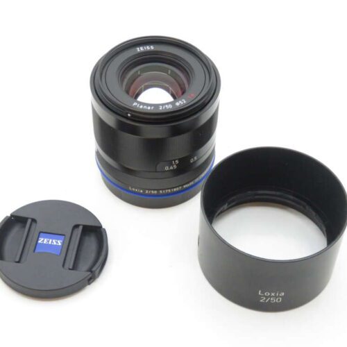 Zeiss Planar 2/50 camera lens with lens cap and lens hood.