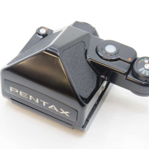 Pentax camera prism viewfinder with attached light meter, black and silver design.