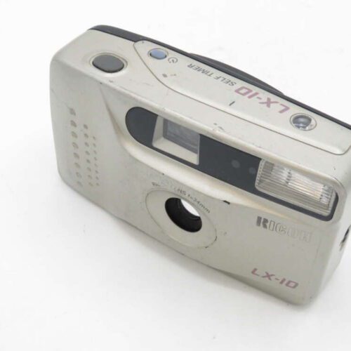 Silver Ricoh LX-10 camera with built-in flash and self-timer button.