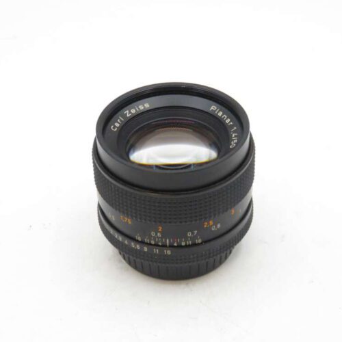 Camera lens with "Carl Zeiss Planar 1.4/50" text.