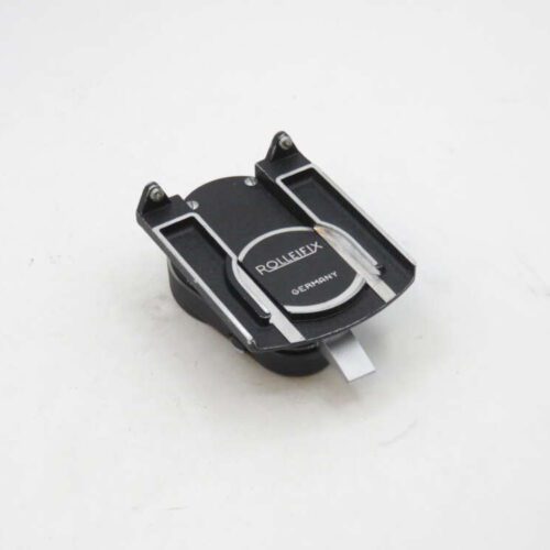 A black Rolleifix camera accessory with silver accents, labeled "GERMANY," on a white background.