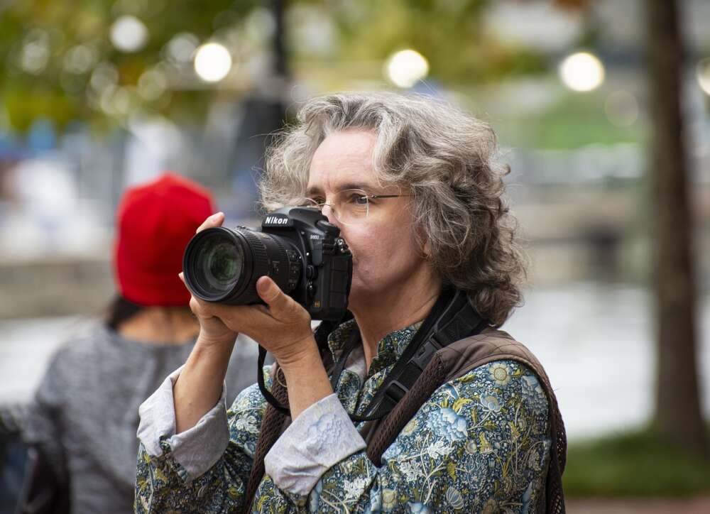Woman taking pictures from Nikon camera