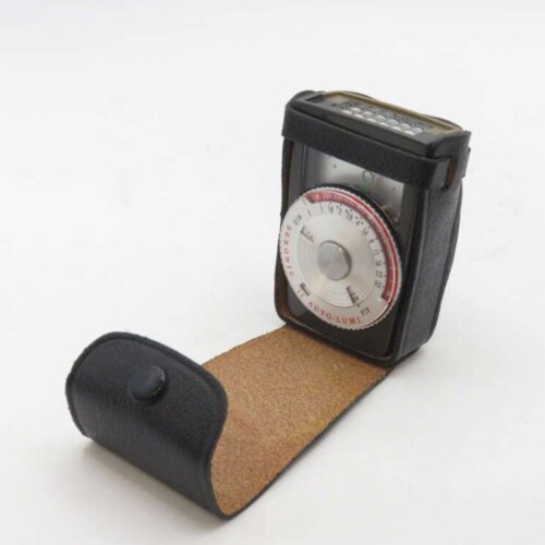 A vintage Sekonic Auto-Lumi light meter in a black leather case with the flap open.